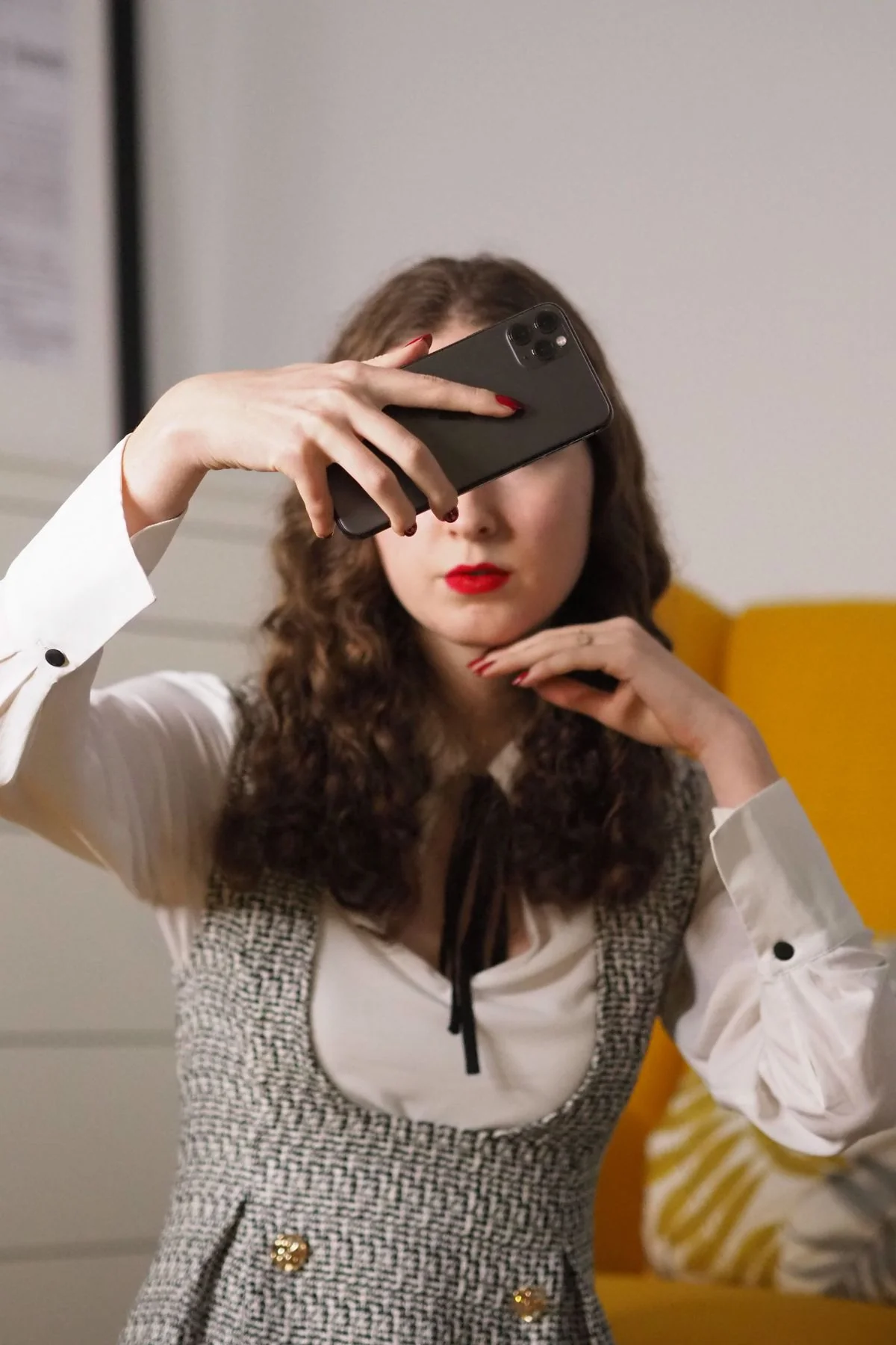 A woman creating a self-portrait with her phone